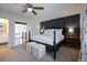 Bright bedroom featuring a dark accent wall, plush carpet, and ample natural light at 7233 S Harrison Way, Centennial, CO 80122