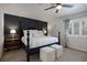 Stylish bedroom featuring a dark accent wall, plush carpet, and ample natural light at 7233 S Harrison Way, Centennial, CO 80122