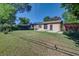 Large, grassy backyard with a concrete patio, partial fence, and mature trees, offering privacy and space at 6054 Iris Way, Arvada, CO 80004