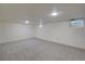 Finished basement area with carpet and recessed lighting at 6054 Iris Way, Arvada, CO 80004