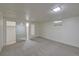 Finished basement area with carpet and a mirrored closet at 6054 Iris Way, Arvada, CO 80004