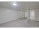 Finished basement area with carpet and a mirrored closet at 6054 Iris Way, Arvada, CO 80004