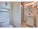 Small renovated bathroom featuring white vanity, toilet, and glass shower at 6054 Iris Way, Arvada, CO 80004