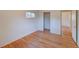 This bedroom features a window and hardwood floors at 6054 Iris Way, Arvada, CO 80004