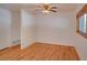 Cozy bedroom with hardwood floors, a ceiling fan, and a window for natural light at 6054 Iris Way, Arvada, CO 80004