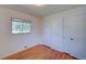 This bedroom features hardwood floors, a window, and a closet at 6054 Iris Way, Arvada, CO 80004
