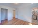 Empty bedroom showing hardwood floors and the bathroom in the background at 6054 Iris Way, Arvada, CO 80004