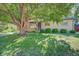 Charming brick home with a large shade tree in a manicured front yard at 6054 Iris Way, Arvada, CO 80004
