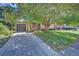 Ranch style home with attached garage, large tree, and well maintained lawn at 6054 Iris Way, Arvada, CO 80004