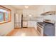 Modern kitchen features white cabinets, stainless steel appliances, and a stylish backsplash at 6054 Iris Way, Arvada, CO 80004