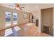 Open floor plan with kitchen, stainless appliances, hardwood floors, and double doors to the back at 6054 Iris Way, Arvada, CO 80004