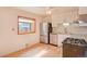 Bright kitchen featuring stainless steel appliances, white cabinets, and a window above the sink at 6054 Iris Way, Arvada, CO 80004