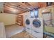 Basement laundry room with washer, dryer and utility sink at 6054 Iris Way, Arvada, CO 80004