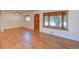 Bright living room featuring beautiful hardwood floors, large windows, and a classic ceiling fan at 6054 Iris Way, Arvada, CO 80004