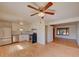 Bright open floor plan with updated kitchen featuring stainless steel appliances and hardwood floors at 6054 Iris Way, Arvada, CO 80004