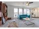 Living room featuring a teal couch and built-in shelving at 5456 Eagle St, Denver, CO 80239