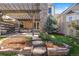 Landscaped backyard featuring a stone patio with a pergola and a small garden at 10000 E Yale Ave # 41, Denver, CO 80231