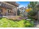 Landscaped backyard with patio, stone accents, and well-maintained lawn at 10000 E Yale Ave # 41, Denver, CO 80231