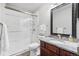 Modern bathroom featuring a marble shower, granite countertop, and dark wood vanity at 10000 E Yale Ave # 41, Denver, CO 80231