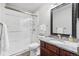 Bathroom showcasing a granite vanity, updated lighting, and modern glass-enclosed shower at 10000 E Yale Ave # 41, Denver, CO 80231