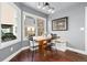 Dining area with a bench and chairs, windows, and hardwood floors at 10000 E Yale Ave # 41, Denver, CO 80231