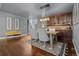 Dining room adjacent to staircase with hardwood floors, stylish lighting, and custom bar area at 10000 E Yale Ave # 41, Denver, CO 80231