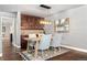Dining area with a wooden table, stylish chairs, and a built-in bar with glass-front cabinets at 10000 E Yale Ave # 41, Denver, CO 80231
