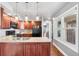 Well-lit kitchen with wood cabinets, granite countertops, a stainless steel sink, and modern appliances at 10000 E Yale Ave # 41, Denver, CO 80231