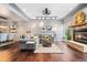 Inviting living room featuring a stone fireplace, modern lighting, and comfortable gray sectional couch at 10000 E Yale Ave # 41, Denver, CO 80231