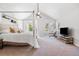Bright main bedroom featuring a sitting area, large bed and multiple windows for natural light at 10000 E Yale Ave # 41, Denver, CO 80231
