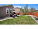 The yard is complete with a grill, patio furniture, green lawn, and a stained privacy fence at 18477 E Amherst Dr, Aurora, CO 80013