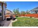 Spacious backyard with a patio area, modern furniture, grill, and a well-maintained lawn at 18477 E Amherst Dr, Aurora, CO 80013