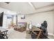 Finished basement featuring carpet floors, a comfortable recliner, and a home office setup at 18477 E Amherst Dr, Aurora, CO 80013