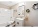 Well-lit bathroom with modern fixtures, a tub/shower combo, and stylish hexagonal wall decor at 18477 E Amherst Dr, Aurora, CO 80013