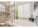 Bathroom featuring a bathtub and marble walk-in shower at 18477 E Amherst Dr, Aurora, CO 80013