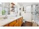 Bright bathroom with double sinks, marble countertops and a modern shower at 18477 E Amherst Dr, Aurora, CO 80013
