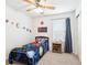 Bright bedroom featuring a ceiling fan, carpet flooring, and a playful solar system theme, perfect for a space at 18477 E Amherst Dr, Aurora, CO 80013