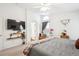 Bright bedroom featuring large windows and mounted TV at 18477 E Amherst Dr, Aurora, CO 80013