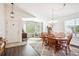 Inviting dining room featuring hardwood floors, a wooden dining set, area rug, and abundant natural light at 18477 E Amherst Dr, Aurora, CO 80013