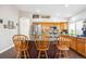 Well-lit kitchen featuring sleek stainless steel appliances, stylish backsplash, and a functional center island at 18477 E Amherst Dr, Aurora, CO 80013