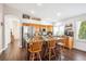 Modern kitchen showcasing granite countertops, stainless steel appliances, wooden cabinetry, and an island with seating at 18477 E Amherst Dr, Aurora, CO 80013