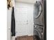 Convenient laundry room featuring stacked washer and dryer, and a door to the exterior at 18477 E Amherst Dr, Aurora, CO 80013