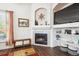 Bright living room with a corner fireplace, built-in shelving, and large windows for natural light at 18477 E Amherst Dr, Aurora, CO 80013