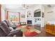Bright living room with large windows, a ceiling fan and cozy furniture at 18477 E Amherst Dr, Aurora, CO 80013