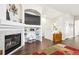 Living room with a fireplace, TV, and decorative shelving at 18477 E Amherst Dr, Aurora, CO 80013