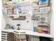 This office has built in white shelving, with containers, and a desk for a craft area at 18477 E Amherst Dr, Aurora, CO 80013