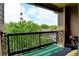Outdoor balcony featuring a black railing, stone columns, and a seating area at 8726 S Kline St # A204, Littleton, CO 80127