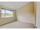 Bedroom with neutral decor, carpet, and a large window with natural lighting at 8726 S Kline St # A204, Littleton, CO 80127