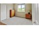 Cozy bedroom featuring a window with natural light, dresser, and neutral carpet at 8726 S Kline St # A204, Littleton, CO 80127