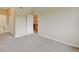 Neutral bedroom features a closet, an open doorway, and neutral carpeting at 8726 S Kline St # A204, Littleton, CO 80127